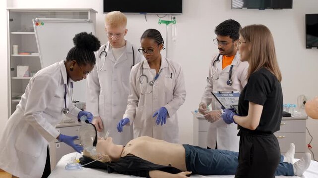 Instructor teaching first aid cardiopulmonary resuscitation course and use of automated external defibrillator workshop