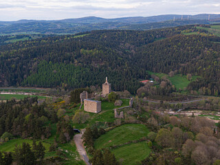 Scenic aerial view of medieval Luc castle ruins nestled in lush green valley
