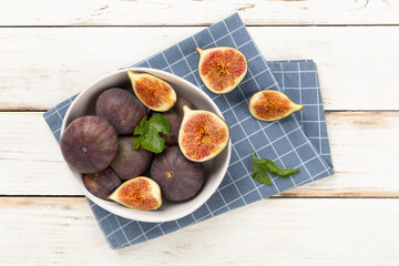 Fresh tasty fig fruits on wooden background, top view
