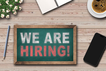 JOIN OUR TEAM text on chalkboard on the wooden background on office desk.