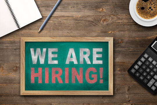 JOIN OUR TEAM text on chalkboard on the wooden background on office desk.