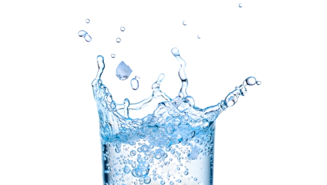Dynamic water splash frozen in time emerging from a glass isolated on transparent background