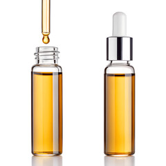 Two glass dropper bottles filled with golden amber liquid isolated on transparent background