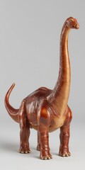 Obraz premium Realistic dinosaur figurine with long neck and tail on plain background