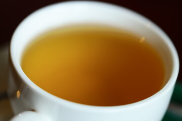 A close-up of a cup of tea and saucer on a table, perfect for still life or interior design images