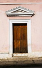 Nostalgic old wooden entrance doors with authentic Mexican charm, decorated with colorful arches and ornate columns, San Cristobal, Chiapas, Mexico