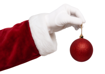 Santa Claus hand in white glove holding a red Christmas ornament ball with golden hanger, isolated on background, symbolizing holiday decoration and festive celebration