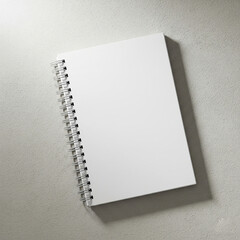 blank notebook on white background. White spiral-bound notebook mockup on a white background. flat lay, diffused lighting.