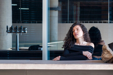 Relaxed woman sitting at outdoor bar counter