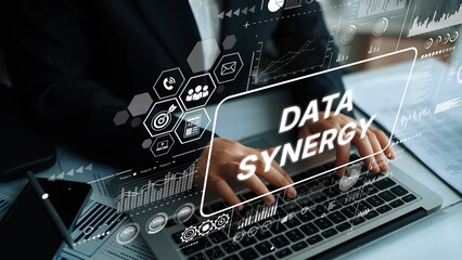 Business Professional Working on Laptop with Data Synergy Graphics Displayed on Screen in Modern Office Environment. Asymptotic smart data analytic.
