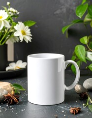 A blank white ceramic mug sits on a dark gray surface, surrounded by fresh white flowers and greenery, evoking a tranquil and inviting atmosphere.