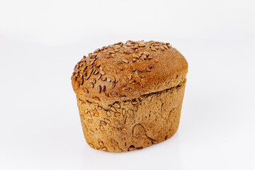 Whole grain bread loaf with sunflower seeds on white background, healthy bakery product