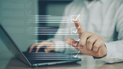 Person interacting with digital checklist or dropdown list on laptop screen, representing selection, decision-making, and online forms.