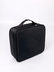 Large black cosmetics suitcase on white background