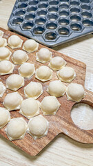Rustic dumpling preparation on worn wooden board whispers tales of Slavic harvest nights and Georgian Supra feasts