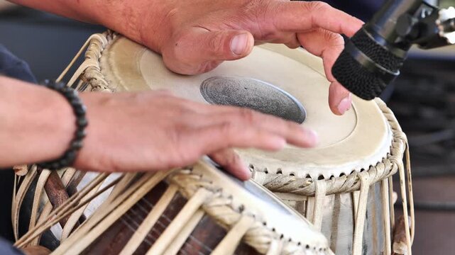 Musician playing tabla drums during a concert in India