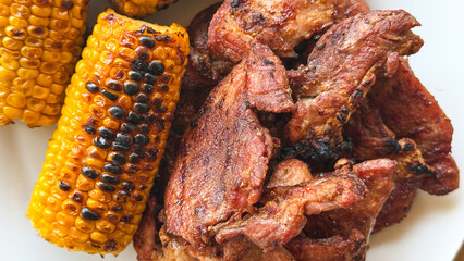 Grilled corn and savory meat evoke summer barbecue nostalgia and New World harvest feasts, rich in...