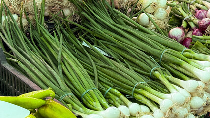 Bundles of verdant scallions whisper culinary secrets, perfect for Lunar New Year feasts and...