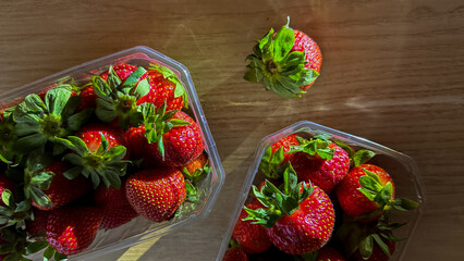 Sunlit strawberries in rustic embrace, embodying midsummer solstice celebrations, vibrant fruit festivities, and nature's succulent bounty renewal