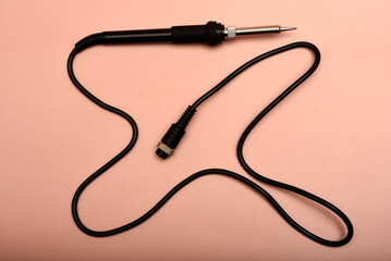 Black soldering iron. Soldering iron for mounting radio elements.