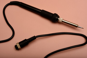 Black soldering iron. Soldering iron for mounting radio elements.