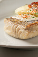 Golden-crusted cod in lemony dill cream, a pescatarian delight dancing with zest on International Day of the Seafarer