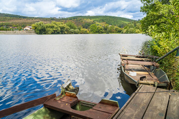 Obraz premium View of a wooden boat parked on a stormy summer day near the Berunka River,Czech