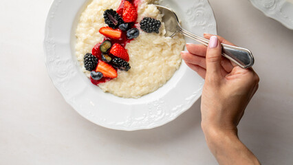 Indulge in creamy rice pudding adorned with vibrant berries, perfect for Midsummer festivities and...