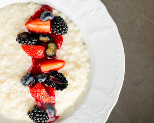 Creamy rice pudding crowned with a cascade of berries, reminiscent of Midsummer's feast, Lunar New Year sweet indulgence