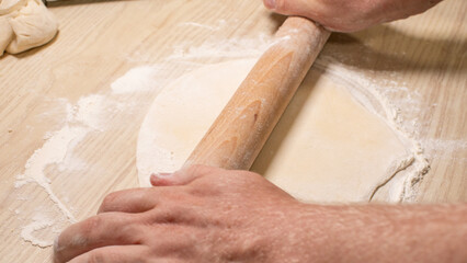 Flour-dusted hands shape dough for Lunar New Year delicacies, blending ancient culinary magic with an artisan's whispering touch