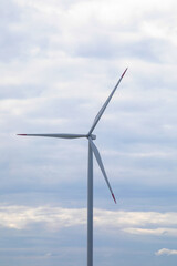 Wind turbine slicing serene skies, whispering the future's clean energy, echoing Global Wind Day and Green Energy Week