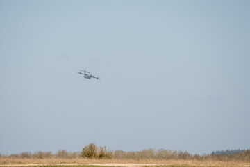 RAF Airbus C.1 A400M Atlas military transport aircraft in flight on a low-level cargo drop run, blue sky