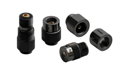 Close-up of five black metal components,  various shapes and sizes, likely for a high-tech application.  Includes threaded connections,  cylindrical and round shapes