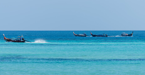 Fishing boats navigate across the serene, tranquil waters, illustrating a perfect harmony in Phi...