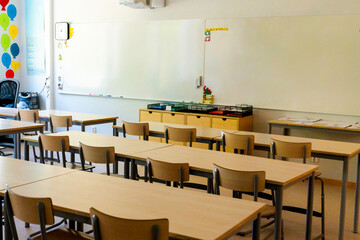 Chairs and tables neatly arranged in empty elementary classroom