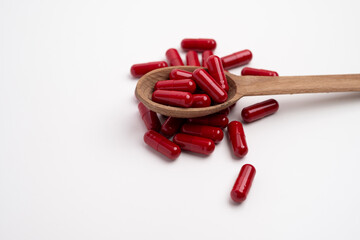 Red Capsule Tablet Medicine.Taking vitamins or medications. Concept of healthcare, medicine, pharmacy, disease prevention  