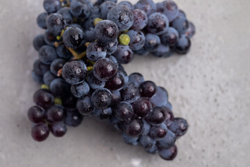 Fresh dark grapes on a light background. Concept of wine vitamins and health.