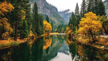 A serene autumnal landscape showcases a tranquil river reflecting vibrant fall foliage and majestic mountains.