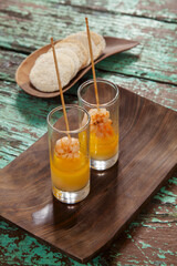 Shrimp skewers served in shot glasses with mango sauce and tapioca