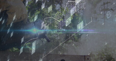 Reaching man wearing gloves operating control panel at outdoor worksite with lens flare, holograms