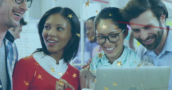 Collaborating team members leaning around silver laptop in office meeting area with star overlays