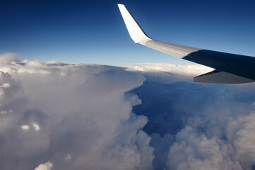 Fototapeta premium View from a window of passenger plane during flight above clouds