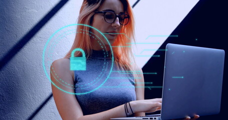 Working woman wearing sleeveless top typing on laptop in home office, with digital lock icon