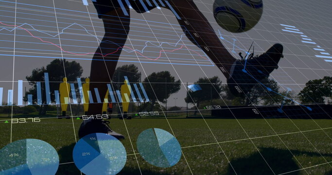 Kicking soccer ball on grass field by male athlete's legs, with cleats and analytics overlay