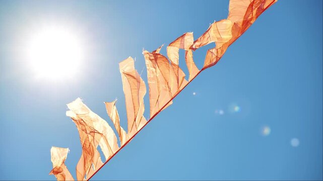 Saffron pennant waving in the wind in India under the sun