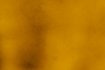 Abstract yellow background with soft cloudy texture and subtle dark shades, ideal for design, wallpaper, or artistic creative backdrop use.