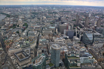 Fototapeta premium Aerial panoramic view looking west across the City of London skyline with modern skyscrapers, historic landmarks and urban architecture under daylight sky