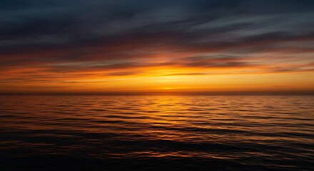 Obraz premium Oceanic fiery sunset reflecting vibrant colors on the rippling water surface for tranquility