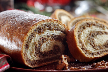 Walnut roll on a wooden background. Croatian orehnjaca