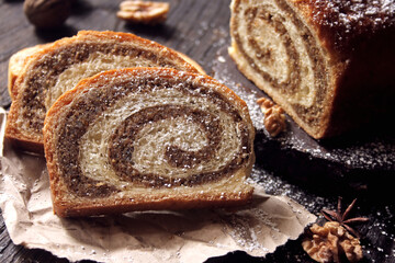 Walnut roll on a wooden background. Croatian orehnjaca